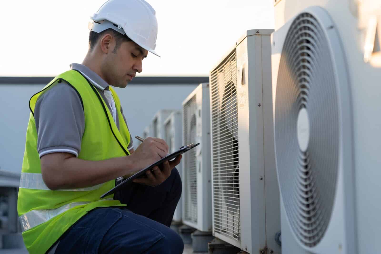 HVAC engineer inspecting rooftop air conditioning units