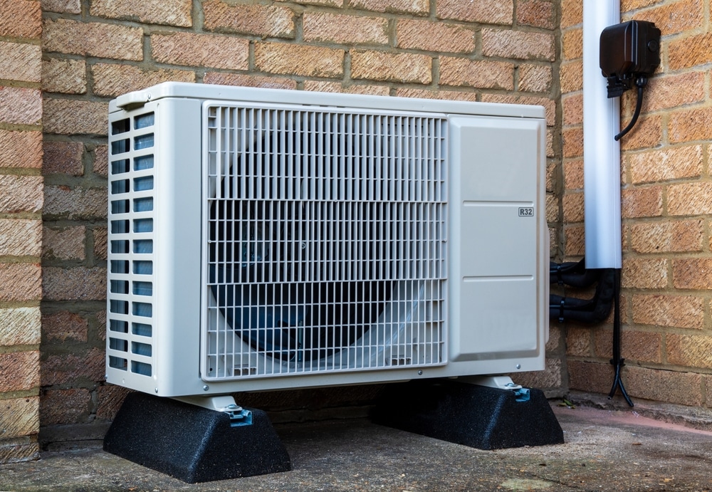Single air source heat pump unit outside modern building